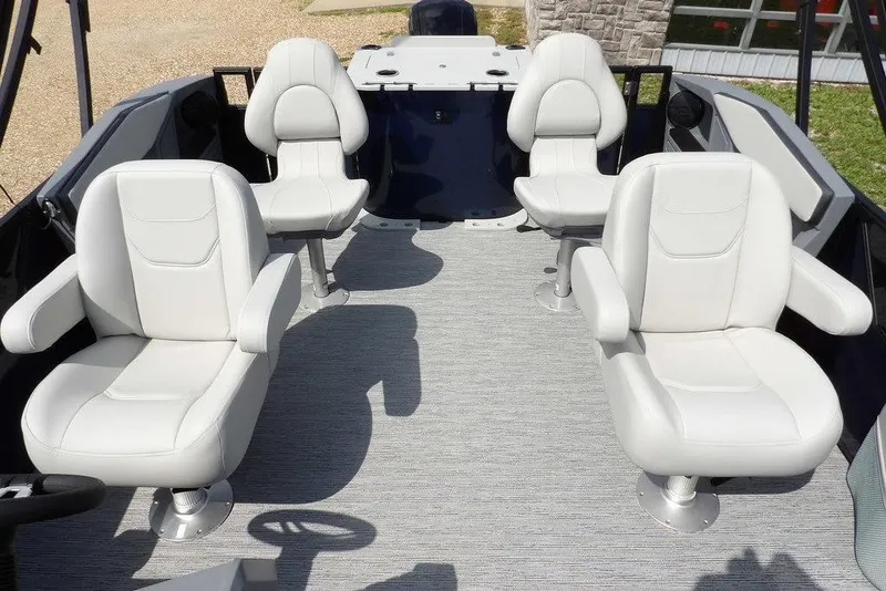 Slide: The Image of 2026 Sylvan R-20 PARTY FISH boat interior with four white cushioned seats. - 25