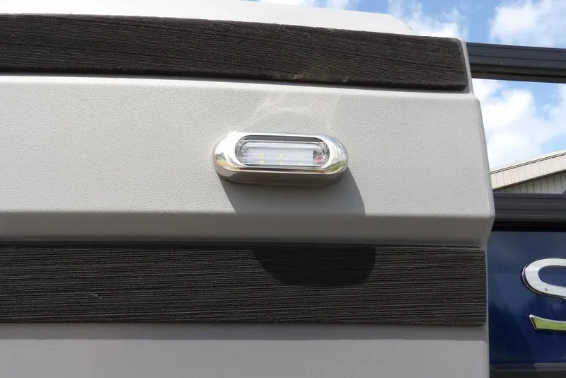 Slide: The Image of Close-up of 2026 Sylvan R-20 PARTY FISH boat exterior with LED light detail. - 34