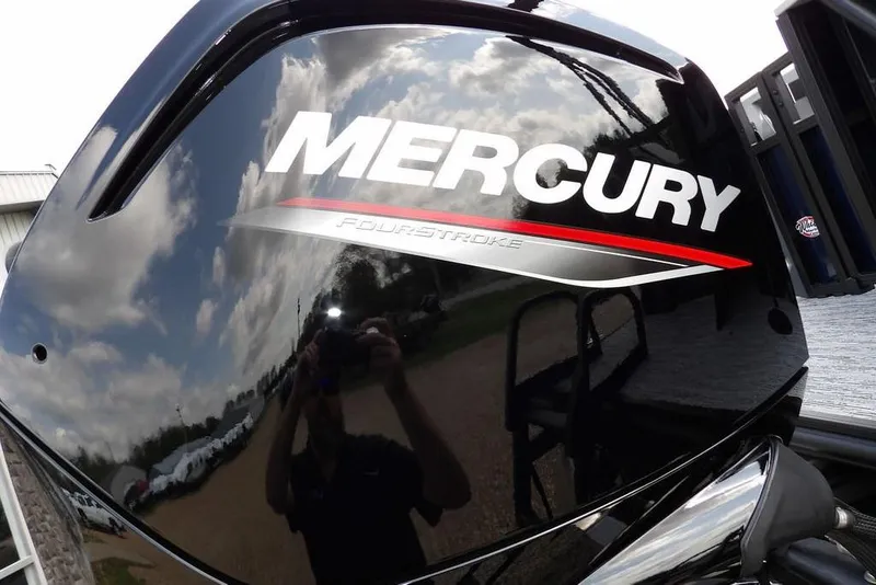Slide: The Image of Mercury FourStroke engine on 2026 Sylvan R-20 PARTY FISH boat, reflecting sky and surroundings. - 35