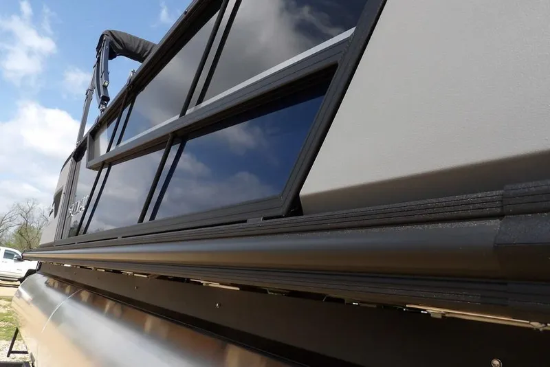 Slide: The Image of 2026 Sylvan R-20 PARTY FISH pontoon boat, sleek design under a blue sky. - 36