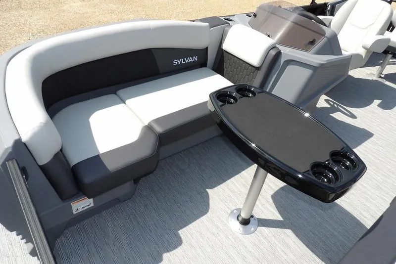 Slide: The Image of 2026 Sylvan R-20 PARTY FISH boat interior with seating and table, featuring cup holders. - 40