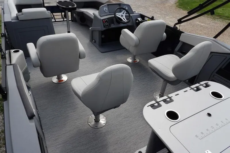 Slide: The Image of 2026 Sylvan R-20 PARTY FISH boat interior with gray seating and fishing table. - 42