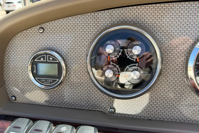 Slide: The Image of Dashboard of a 2013 Regal 1900 Bowrider boat with gauges and controls. - 11