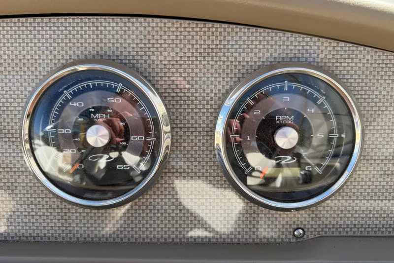 Slide: The Image of Dashboard gauges of a 2013 Regal 1900 Bowrider boat, displaying speed and RPM. - 12