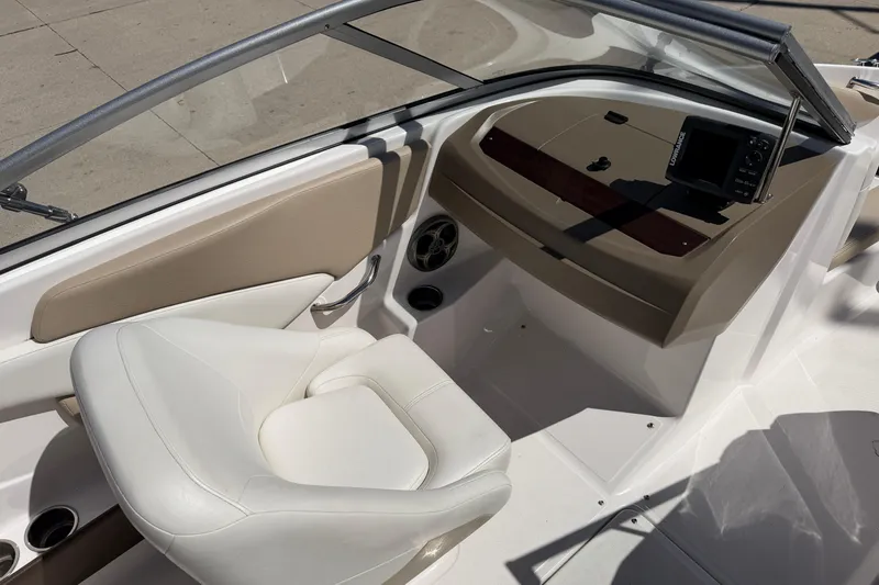 Slide: The Image of 2013 Regal 1900 Bowrider interior with white seating and dashboard controls. - 15