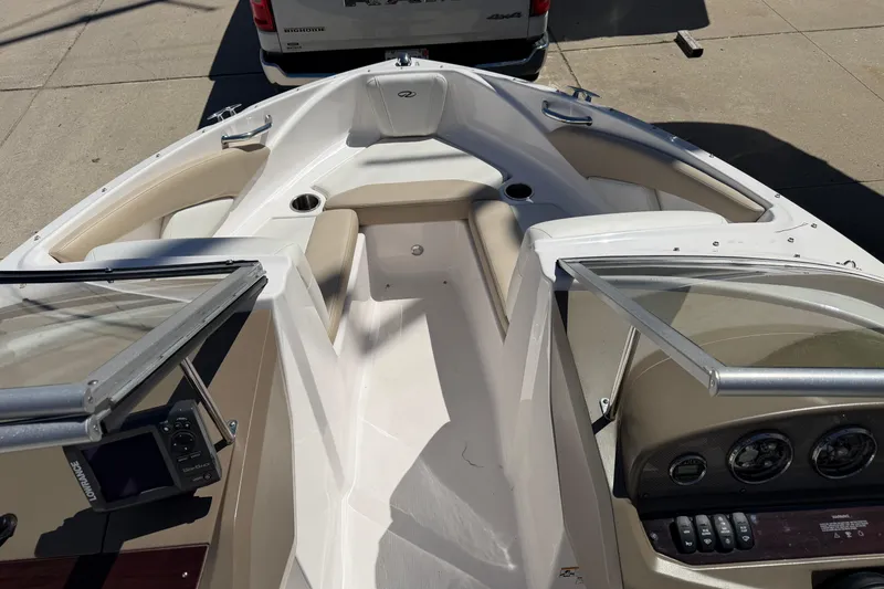 Slide: The Image of 2013 Regal 1900 Bowrider boat interior with open windshield and dashboard controls. - 17