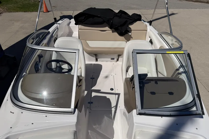 Slide: The Image of 2013 Regal 1900 Bowrider boat interior with open windshield and seating. - 19