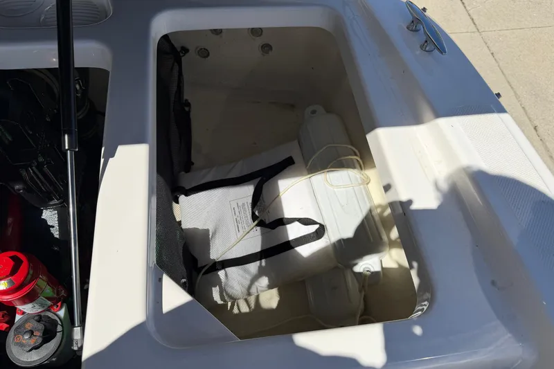 Slide: The Image of Storage compartment of a 2013 Regal 1900 Bowrider boat with safety equipment. - 23