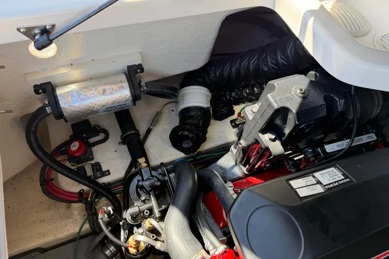 Slide: The Image of Engine compartment of a 2013 Regal 1900 Bowrider boat, showcasing mechanical components. - 26