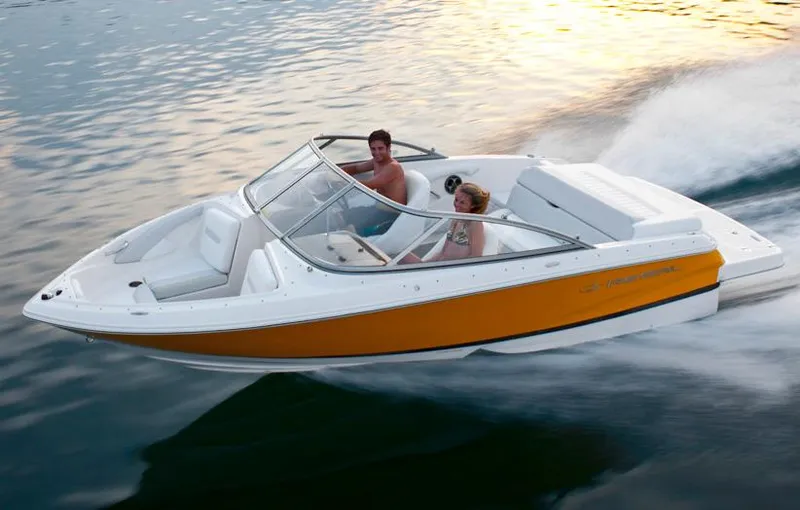 Slide: The Image of Manufacturer Provided Image: 2013 Regal 1900 Bowrider boat cruising on water at sunset. - 30