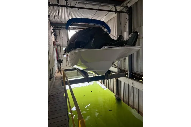 Slide: The Image of 2022 Boston Whaler 170 Montauk boat in a covered dock lift. - 10