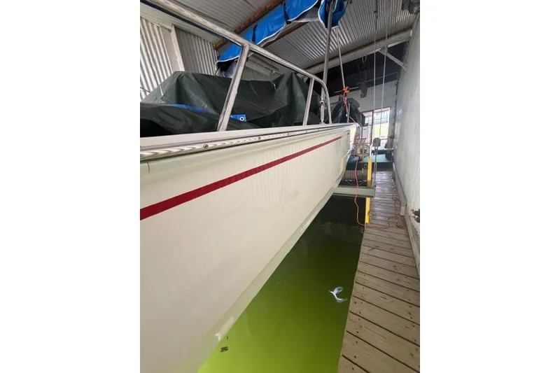 Slide: The Image of 2022 Boston Whaler 170 Montauk boat docked in a covered marina. - 11