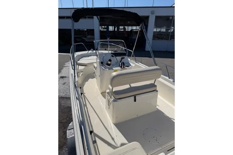 Slide: The Image of 2022 Boston Whaler 170 Montauk boat interior with seating and steering console. - 5