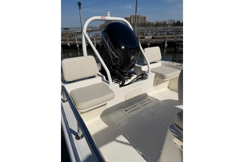 Slide: The Image of 2022 Boston Whaler 170 Montauk boat with Mercury engine, docked at a marina. - 7