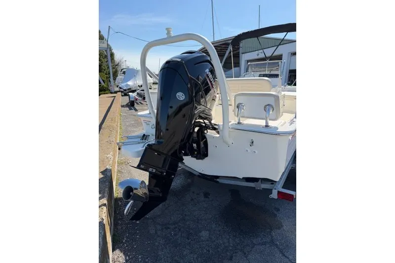Slide: The Image of 2022 Boston Whaler 170 Montauk boat with powerful outboard motor, parked outdoors. - 8