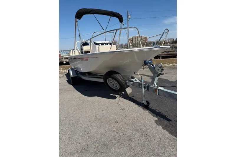 Slide: The Image of 2022 Boston Whaler 170 Montauk boat on trailer, parked outdoors. - 9