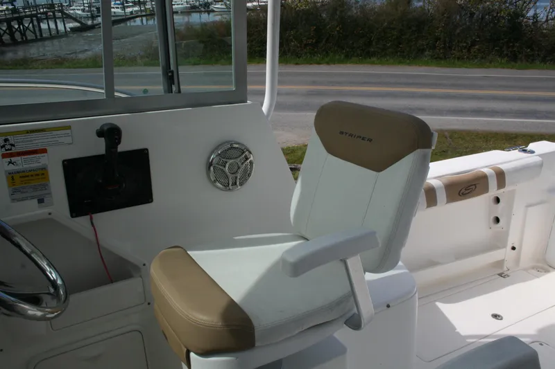 Slide: The Image of 2014 Seaswirl Striper 220 WA boat interior with helm seat and control panel. - 11