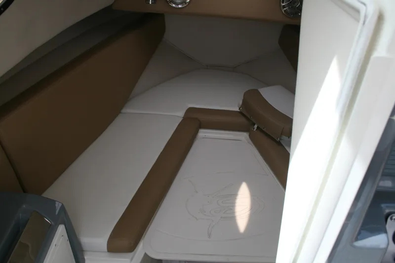 Slide: The Image of 2014 Seaswirl Striper 220 WA cabin interior with cushioned seating and storage space. - 14