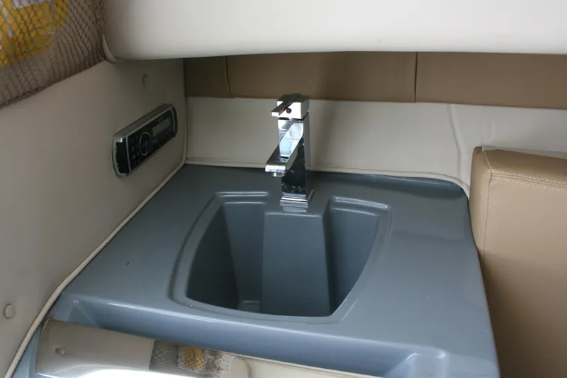 Slide: The Image of 2014 Seaswirl Striper 220 WA cabin sink with modern faucet and stereo system. - 15