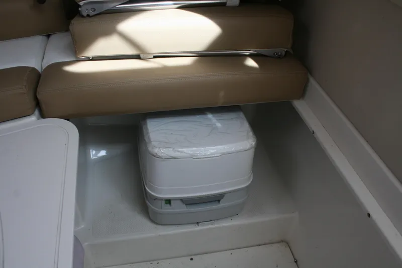 Slide: The Image of 2014 Seaswirl Striper 220 WA cabin interior with portable toilet under seat. - 18