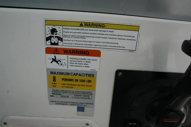 Slide: The Image of Warning labels on 2014 Seaswirl Striper 220 WA boat, indicating safety and capacity limits. - 20