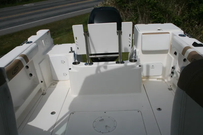 Slide: The Image of 2014 Seaswirl Striper 220 WA boat interior with seating and storage compartments. - 21