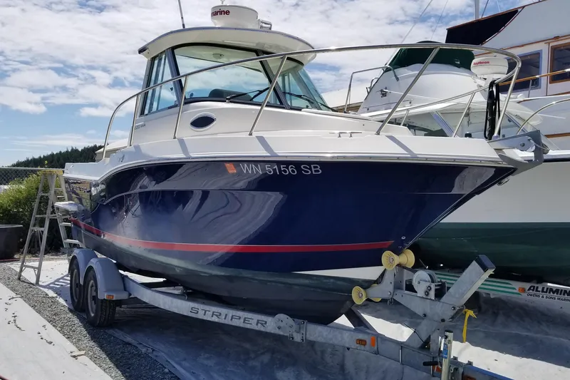 Slide: The Image of 2014 Seaswirl Striper 220 WA boat on trailer under clear sky. - 5