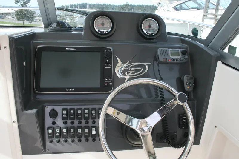 Slide: The Image of Dashboard of 2014 Seaswirl Striper 220 WA with steering wheel and navigation equipment. - 7