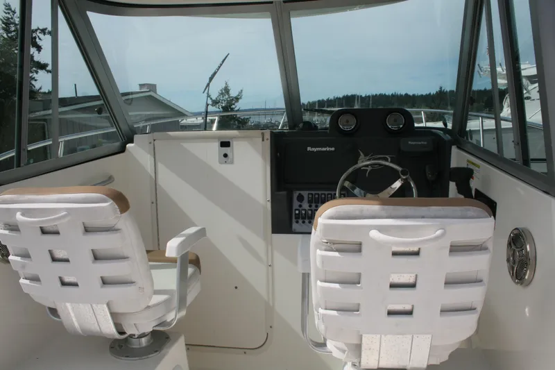 Slide: The Image of Interior view of 2014 Seaswirl Striper 220 WA boat cockpit with steering wheel and seats. - 9