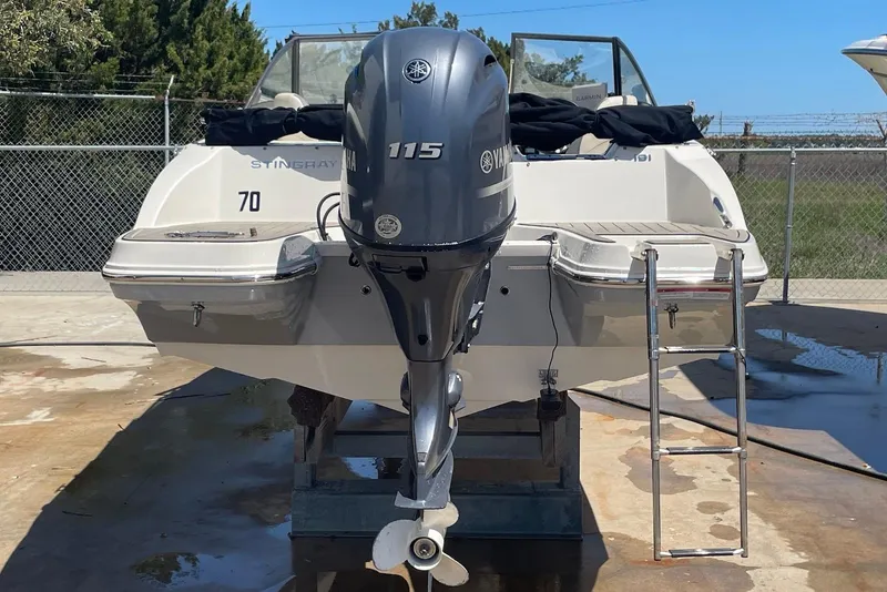 Slide: The Image of 2023 Stingray 191 DC boat with Yamaha 115 engine, parked on concrete. - 4