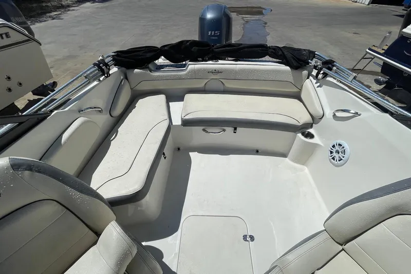 Slide: The Image of 2023 Stingray 191 DC boat interior with cushioned seating and speaker system. - 8