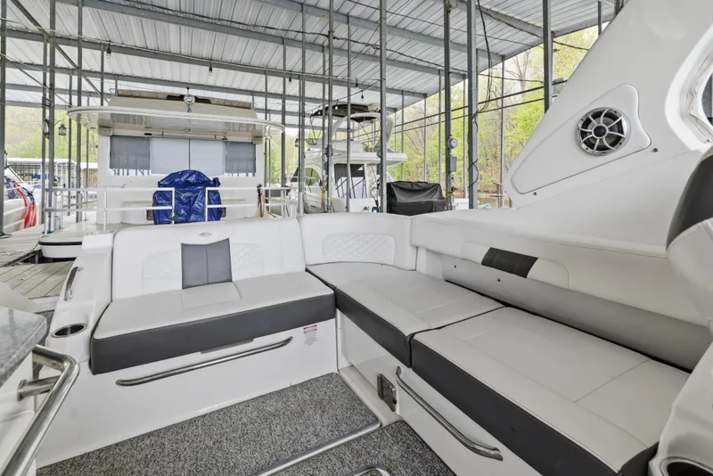 Slide: The Image of Interior view of 2014 Chaparral 327 SSX boat with spacious seating under a covered dock. - 21