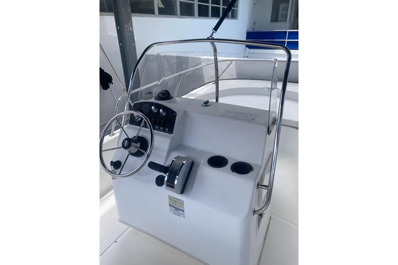 Slide: The Image of 2007 Boston Whaler 190 Montauk boat console with steering wheel and controls. - 11