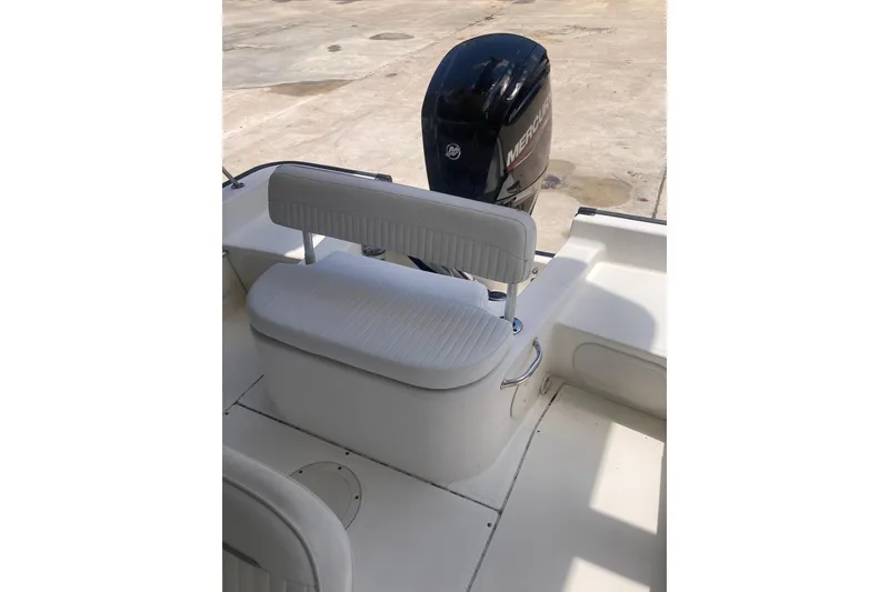 Slide: The Image of 2007 Boston Whaler 190 Montauk boat interior with seating and Mercury outboard motor. - 14