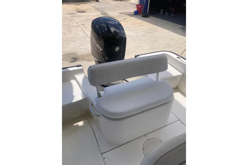 Slide: The Image of 2007 Boston Whaler 190 Montauk boat interior with Mercury engine and cushioned seating. - 15