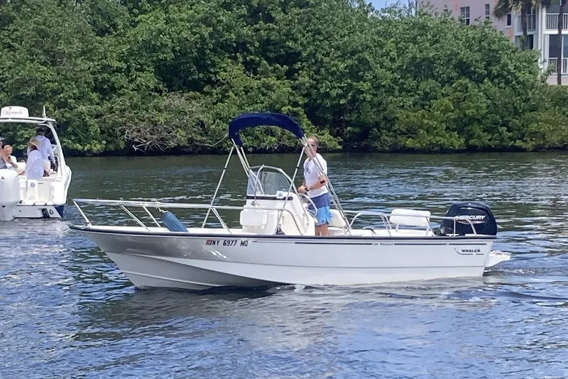 Slide: The Image of 2007 Boston Whaler 190 Montauk boat cruising on a scenic waterway. - 2