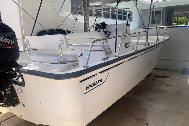 Slide: The Image of 2007 Boston Whaler 190 Montauk boat with Mercury engine, parked in a garage. - 20