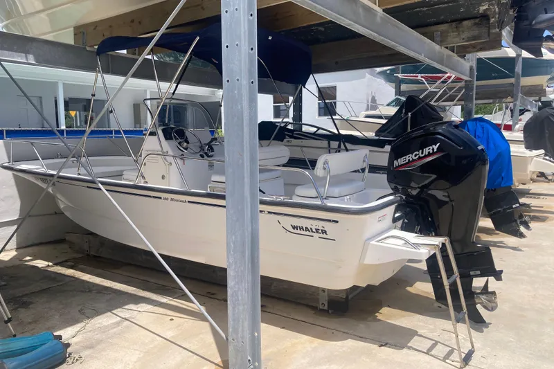 Slide: The Image of 2007 Boston Whaler 190 Montauk boat with Mercury outboard motor in storage. - 21