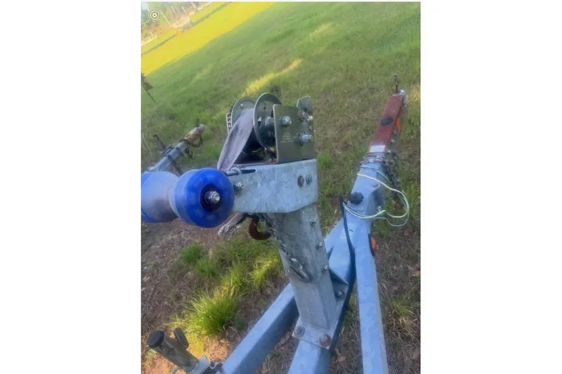 Slide: The Image of Trailer hitch and winch for 2007 Boston Whaler 190 Montauk on grassy background. - 28