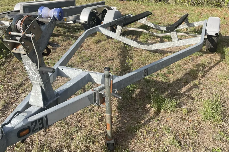 Slide: The Image of Boat trailer for 2007 Boston Whaler 190 Montauk on grassy area. - 29