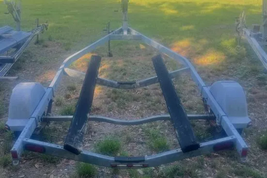 Slide: The Image of Trailer for 2007 Boston Whaler 190 Montauk boat on grassy area. - 30