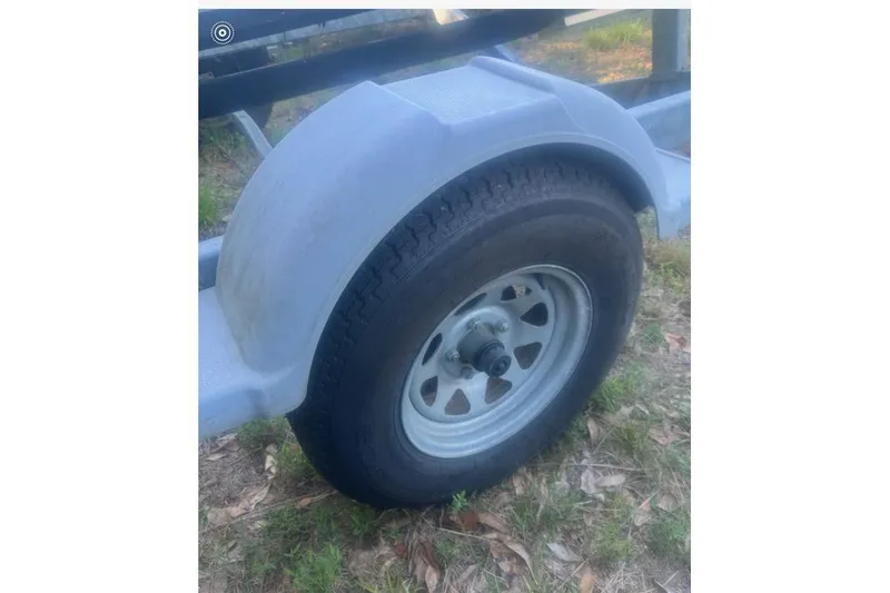 Slide: The Image of Trailer wheel for 2007 Boston Whaler 190 Montauk, parked on grass. - 31