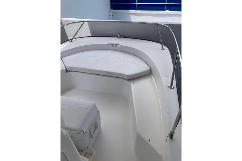 Slide: The Image of 2007 Boston Whaler 190 Montauk boat interior with cushioned seating and stainless steel railings. - 5