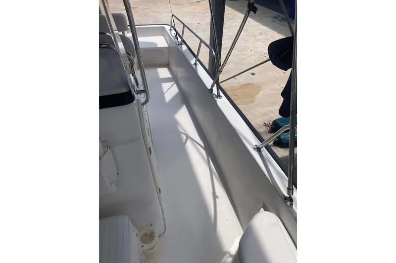 Slide: The Image of 2007 Boston Whaler 190 Montauk boat interior with clean white deck and railing. - 7