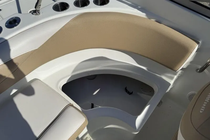 Slide: The Image of 2014 SouthWind 212sd boat interior with beige seating and storage compartment. - 12