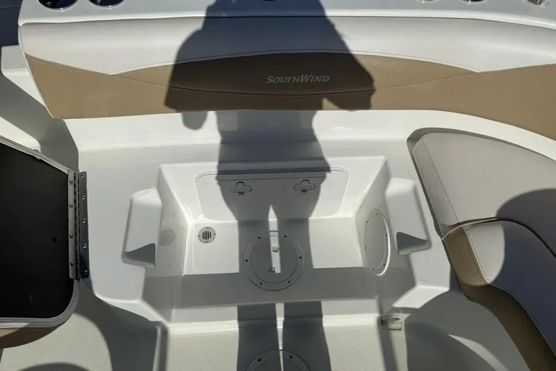 Slide: The Image of Interior of a 2014 SouthWind 212sd boat, featuring seating and storage compartments. - 13