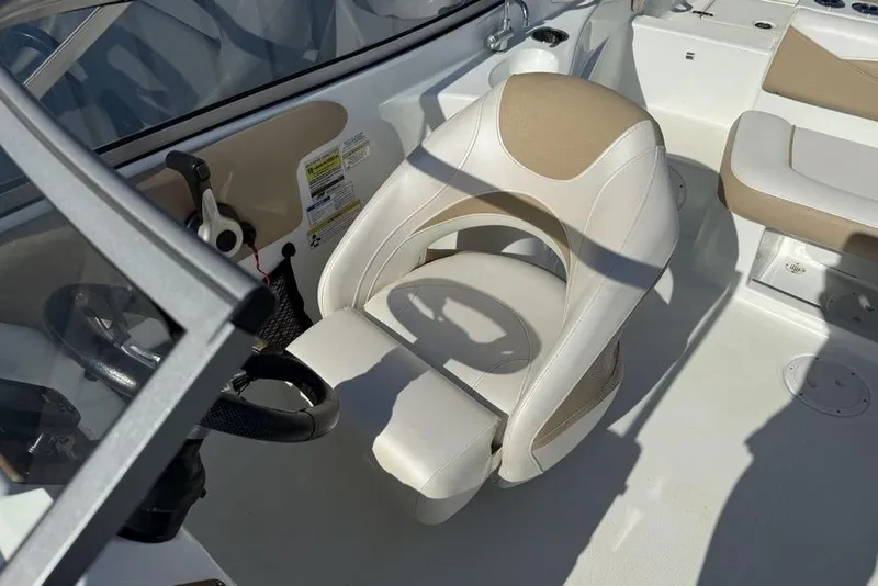 Slide: The Image of 2014 SouthWind 212sd boat interior with beige and white seating and steering wheel. - 15
