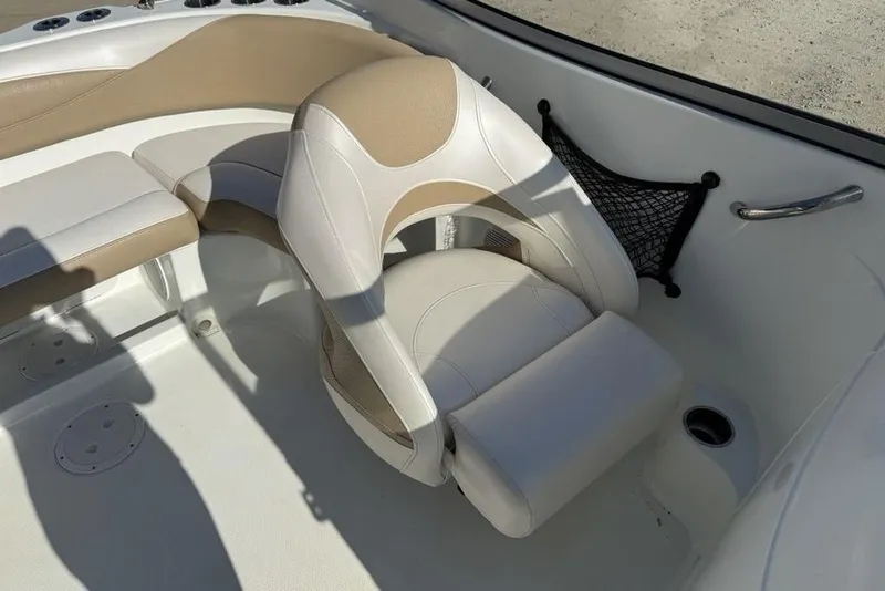 Slide: The Image of 2014 SouthWind 212sd boat interior with beige and white seating, cup holder, and storage net. - 16
