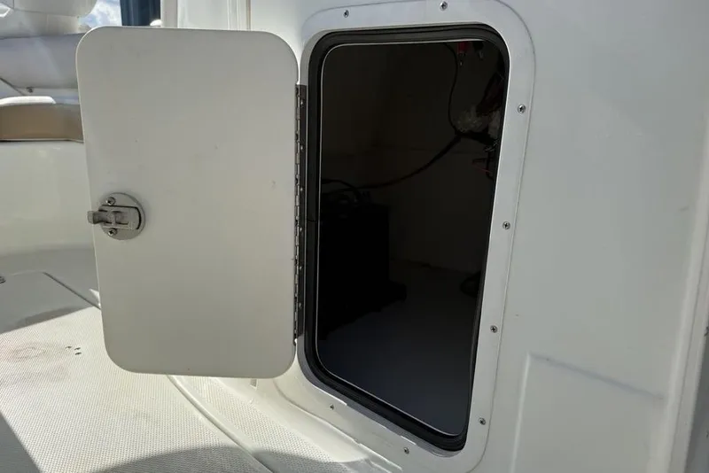 Slide: The Image of Open storage compartment on a 2014 SouthWind 212sd boat. - 18