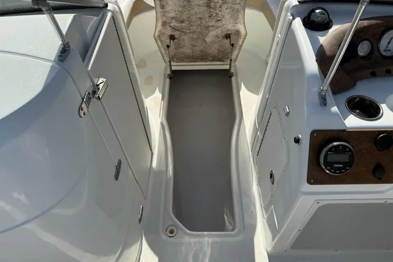 Slide: The Image of Interior view of a 2014 SouthWind 212sd boat, featuring dashboard and seating area. - 19
